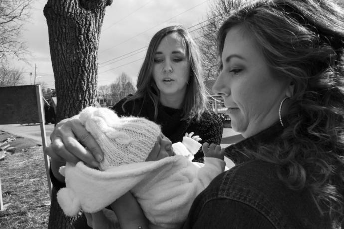 Samantha Engelhardt (right), a recovering addict, shows her newborn baby to the photographer Lori Swadley, who has been documenting the opioid epidemic in the Martinsburg area.